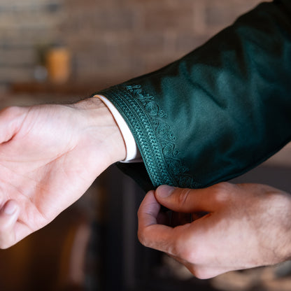 Close-up view of the intricate embroidery detail on the cuff of the Emerald Green Moroccan Kaftan.