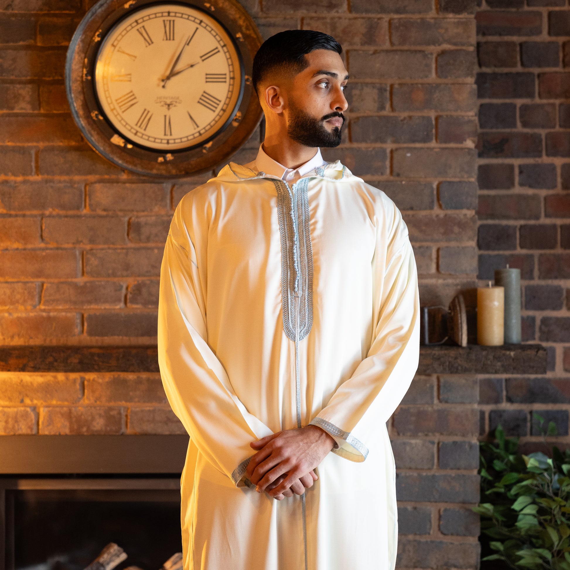 Close-up of embroidery and stitching details on pearl and sky Moroccan djellaba