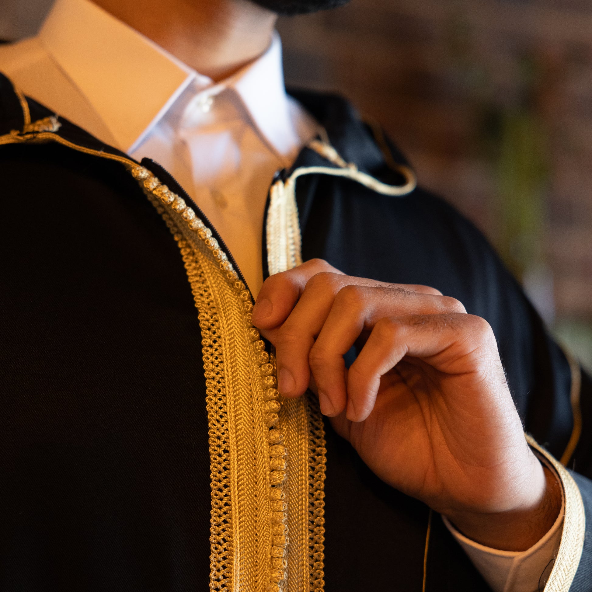 Close-up of the elegant embroidery on the chest and collar of the royal-black-moroccan, showing intricate details.