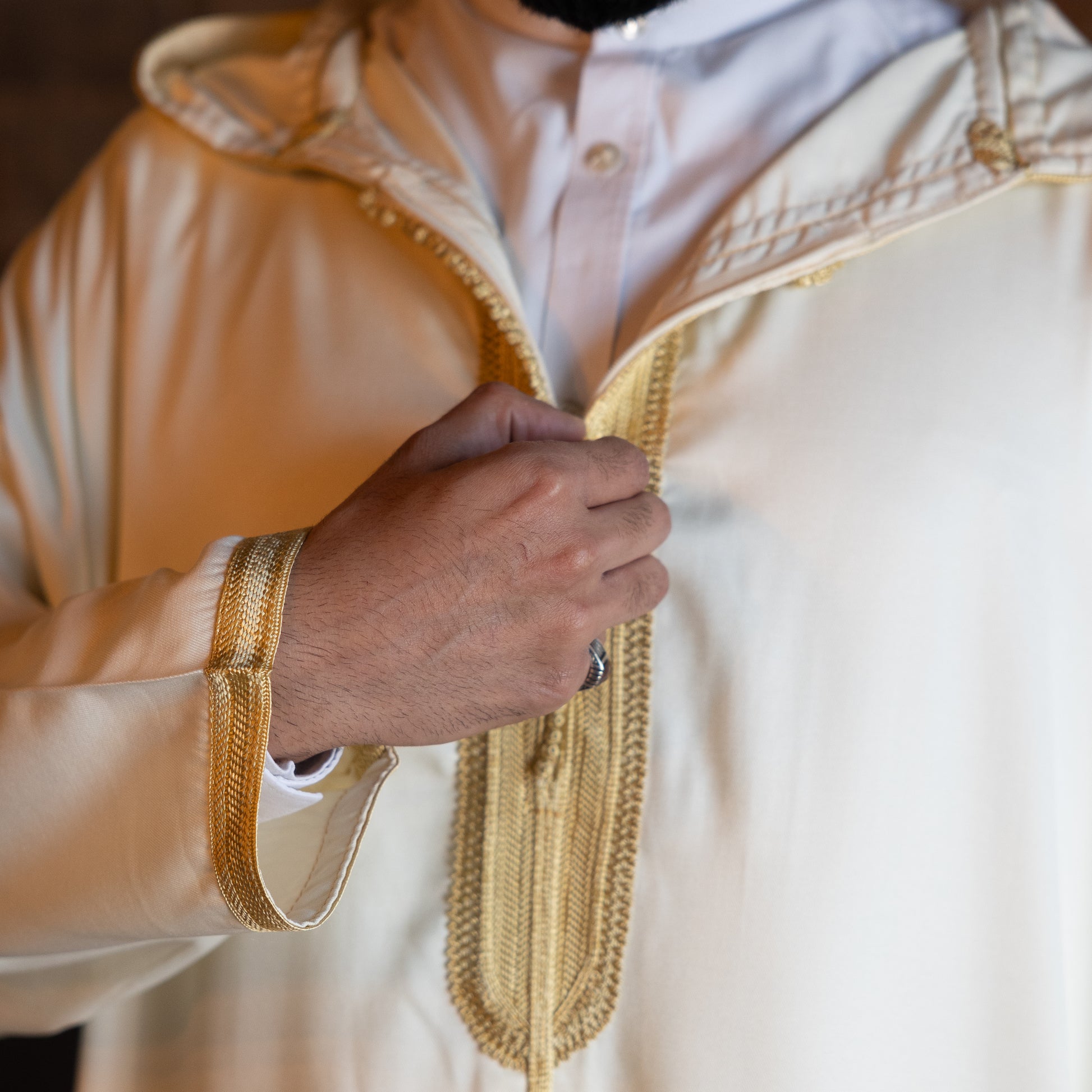 Close-up of chest embroidery design on royal white Moroccan djellaba