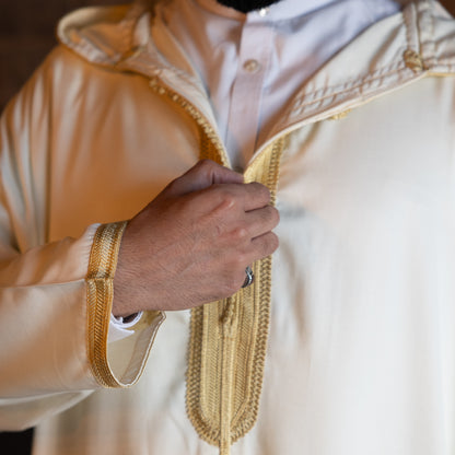 Close-up of chest embroidery design on royal white Moroccan djellaba